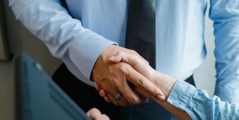 Handshake symbolising partnership and trust in after-sales consultancy
