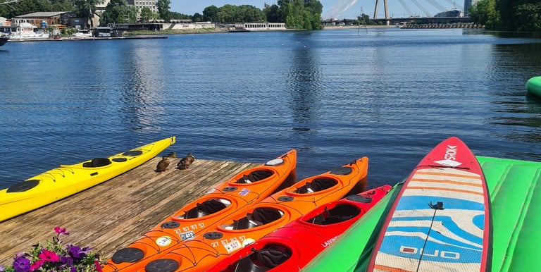 Kayaks and a SUP board at the Party Port Riga