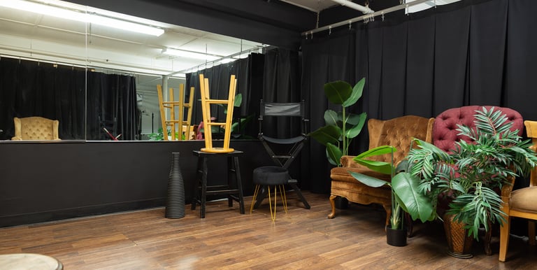 a photo studio with large mirror and black walls