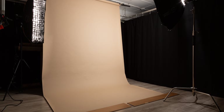 a photo studio with a tan seamless backdrop paper rolled out