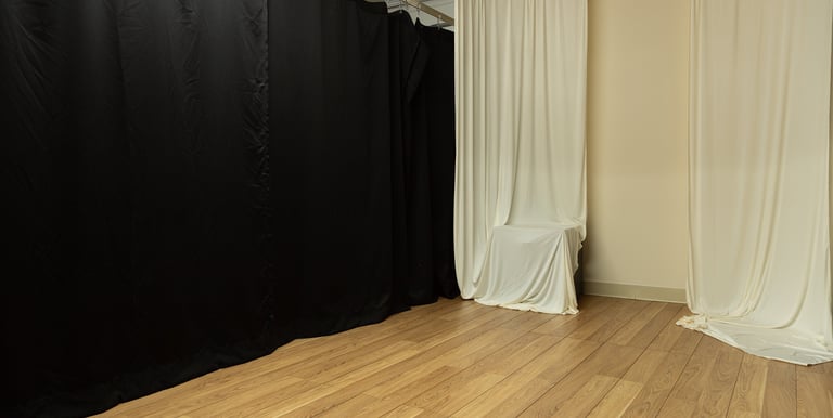 a photo studio with ivory curtains