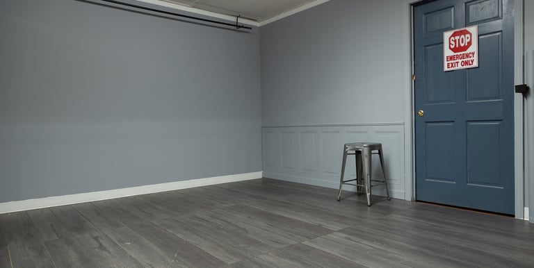a photo studio room with gray walls and panels