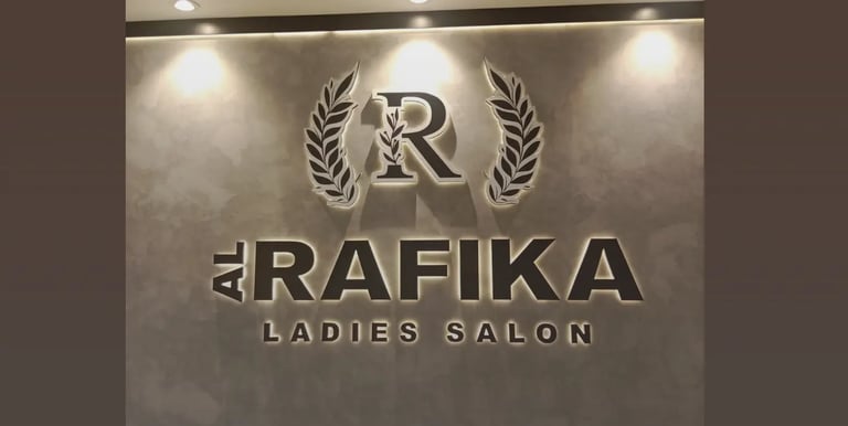  Salon backlit logo Aluminium signage on a textured gray wall with laurel wreath design.