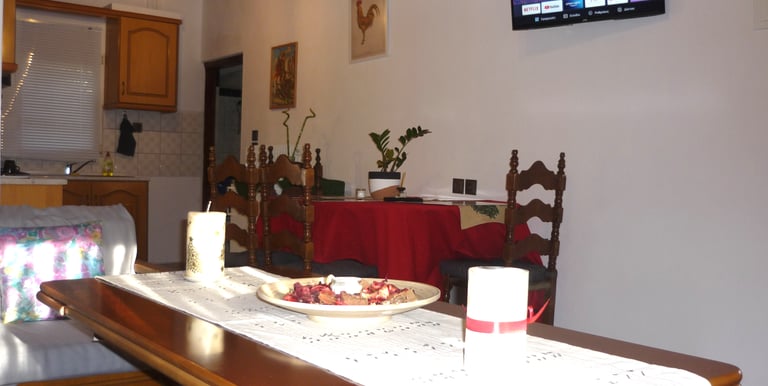 a table with a bowl of fruit and candles
