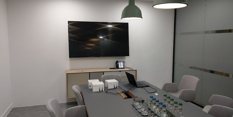 Xonference sstem and TV mounted on a wall in a boardroom