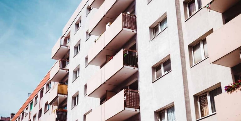 a building with a bunch of flowers in the foreground