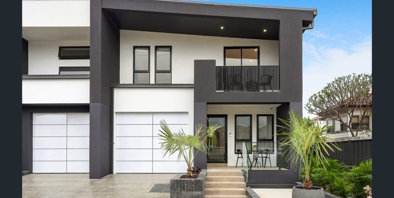 a house with a large white garage door and a large white garage door