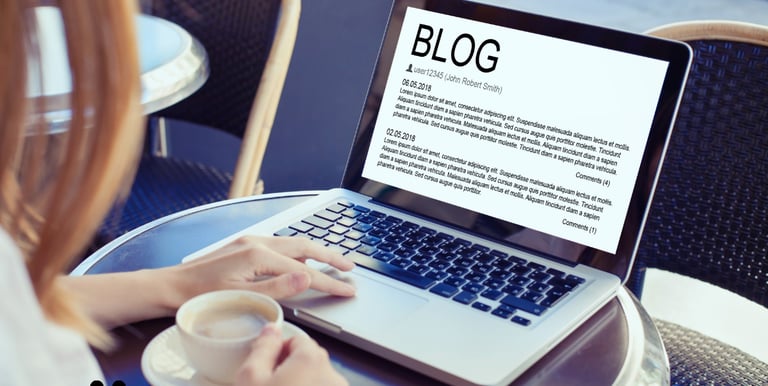 Person using a laptop to draft a blog post, focused on digital content writing services.