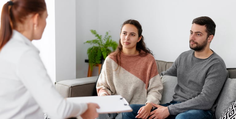 a woman in a wheelchair is being interviewed by a man in a wheelchair