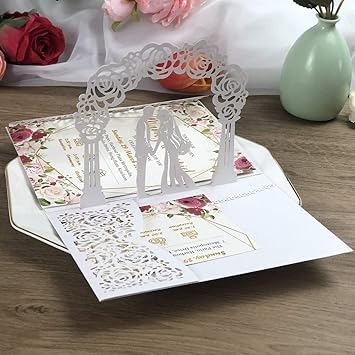a wedding card with a couple of people standing in front of a bouquet