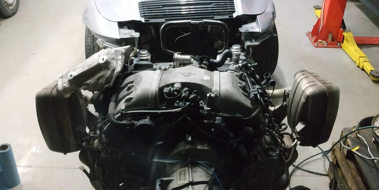 an Enlab car with a engine and a car in the background