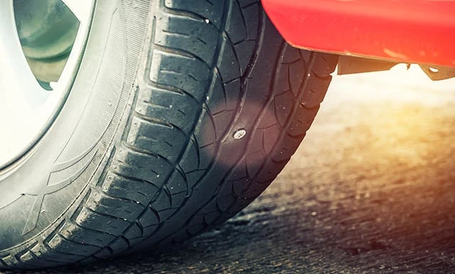 a close up of a punctured tyre on a car
