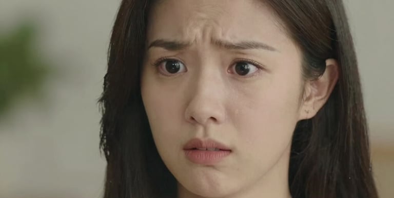 A young adult sitting peacefully by a window, practicing deep breathing with soft natural light.