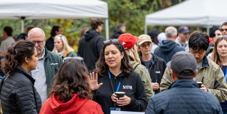 A team workshop with leadership coaching and training materials spread out on a rustic wooden table.