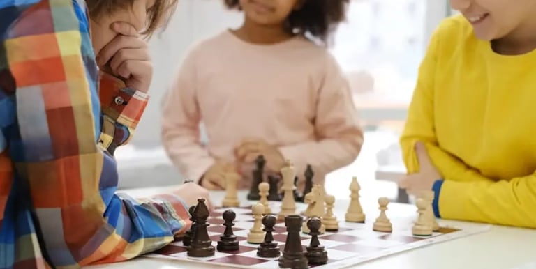 a group of children playing chess in a room