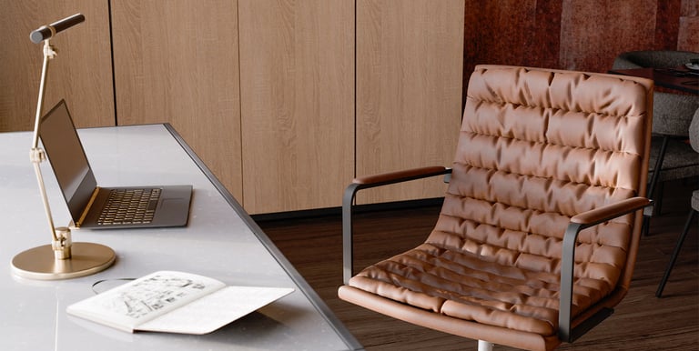 An image of a desk and office chair shown in rendered view on the computer in Blander.