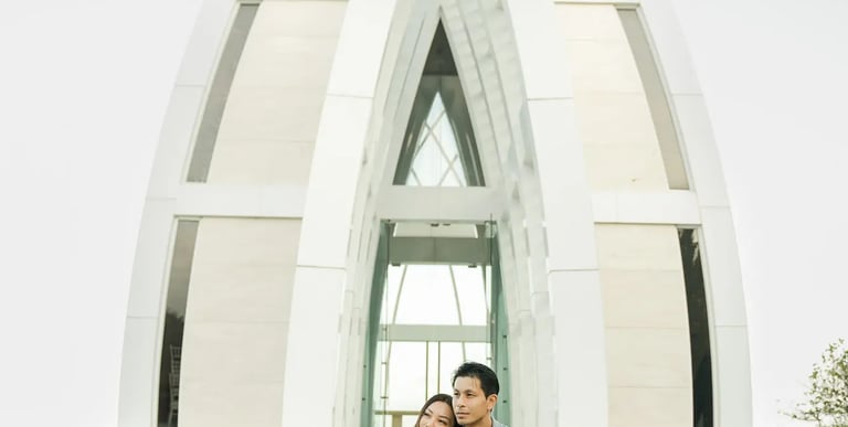 Couple sitting together in front of the chapel during a luxury family photography session at The Ritz-Carlton Bali.