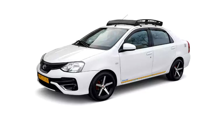 White Toyota Etios one way taxi by Saini taxi services with a luggage carrier rack