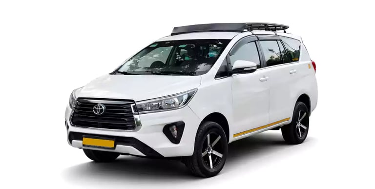White Toyota Innova Crysta one way taxi by Saini taxi services with a luggage carrier rack