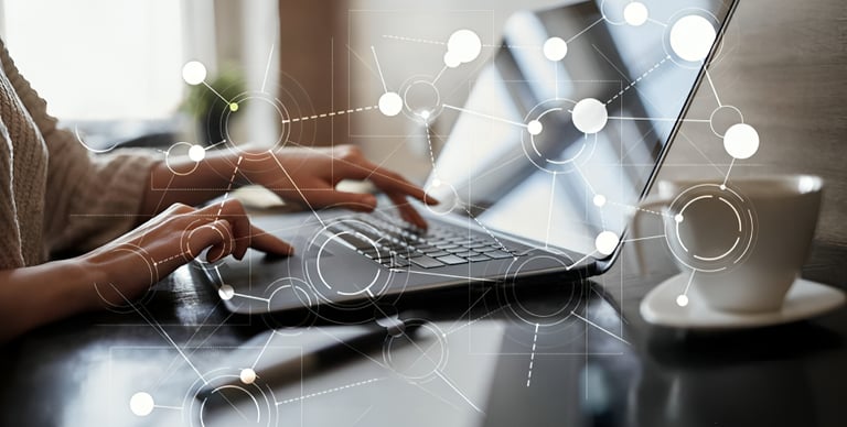 a woman is typing on a laptop computer