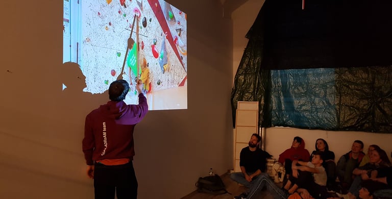a man standing in front of a projection screen