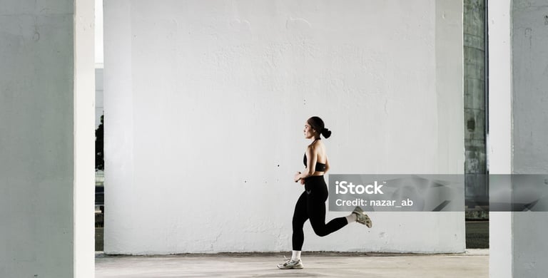 a woman running in a gym suit