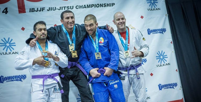 a group of people standing on a stage with medals