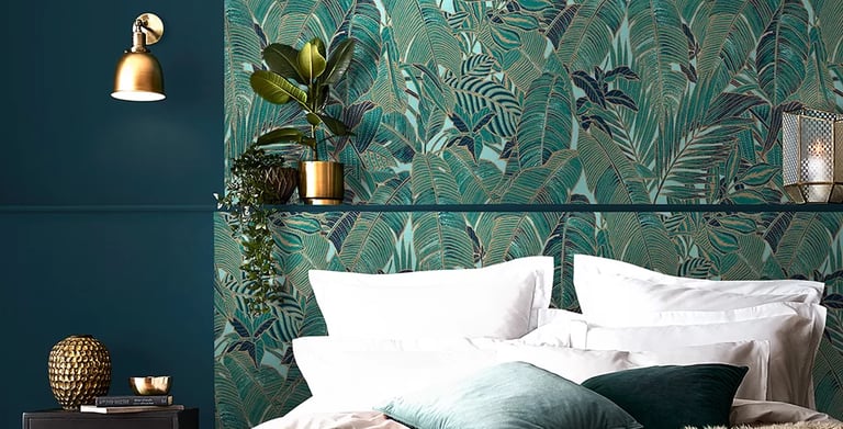Elegant bedroom featuring tropical teal palm leaf wallpaper and luxury gold decor accents.