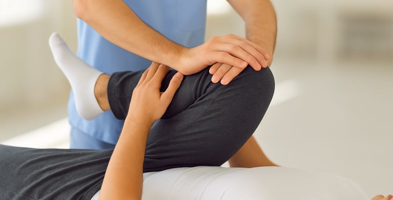 Physiotherapist treating spinal stenosis with back mobilization techniques.