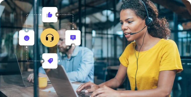 a woman in a yellow shirt is sitting at a table with a laptop and a