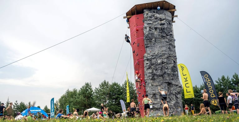 people climbing on a climbing tower