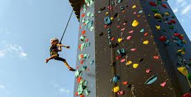 a child climbing on a climbing tower