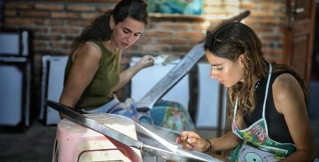 a woman doing batik in a batik studio