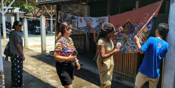 a group of people checking their batik works