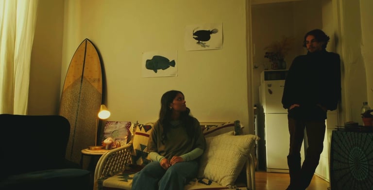 a man and woman sitting on a couch in a living room
