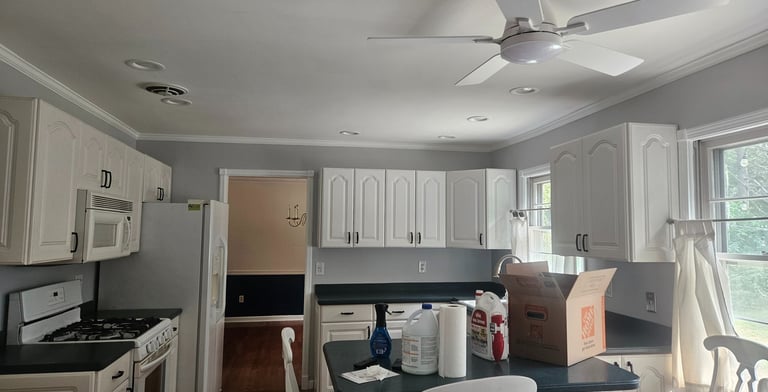 a kitchen with a ceiling fan and a ceiling fan