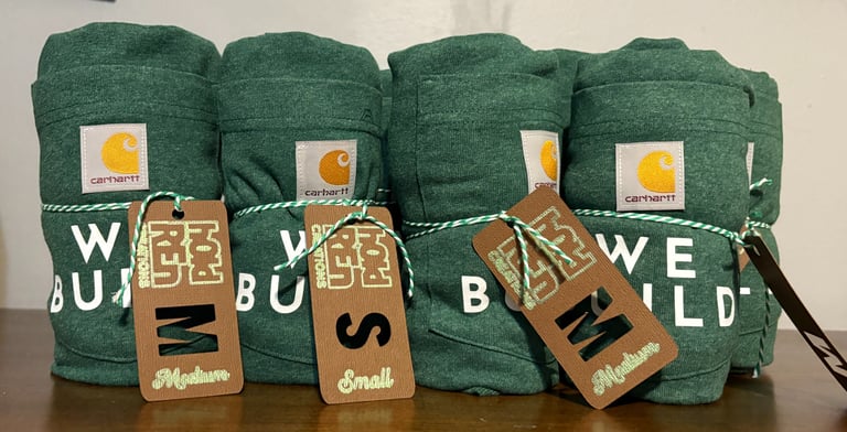 rolled up t-shirts with size labels on them