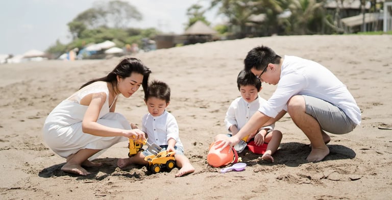 Family playing together on the beach during a natural family photography session in Seminyak Bali