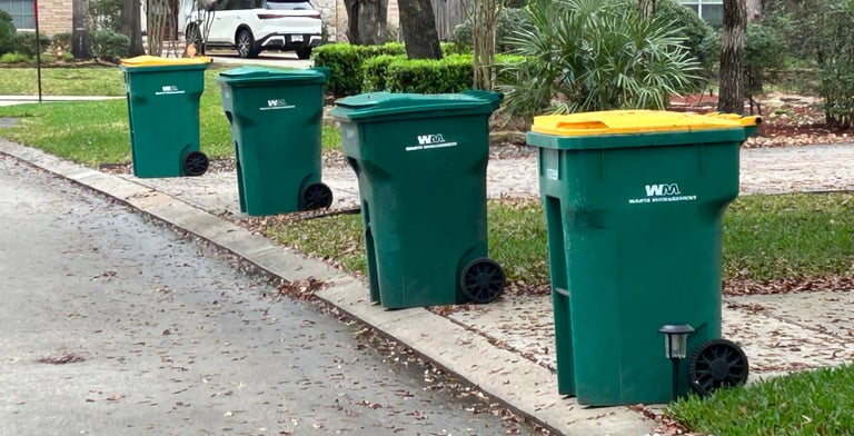 Trash Can Caddie valet service lining up green and yellow trash cans for pickup in The Woodlands, Te