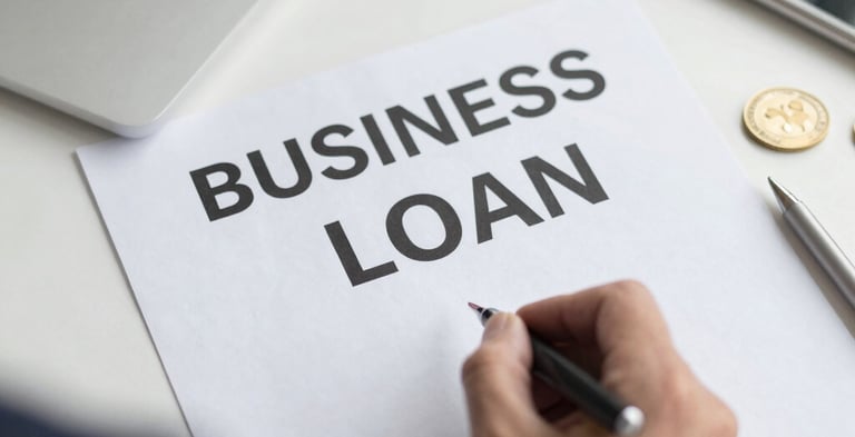 An entrepreneur reviewing plans in a bright office filled with natural light.