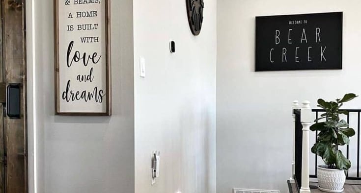 Close-up of baseboard trim installed along hardwood flooring.