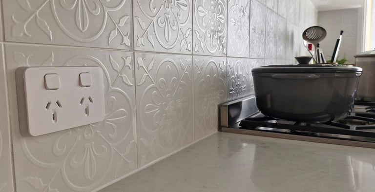 a white power point above a bench in a kitchen