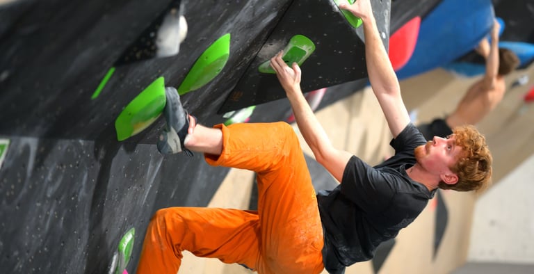 a man bouldering in a climbing competition