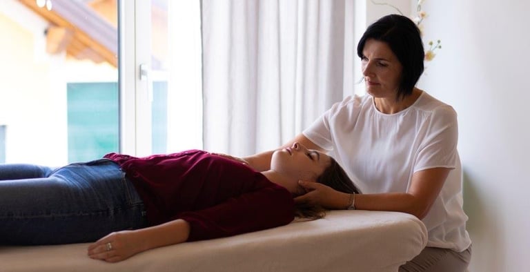 Person liegt auf einer Liege, Hannelore Freischlager macht IKA Craniosacrale Körperarbeit
