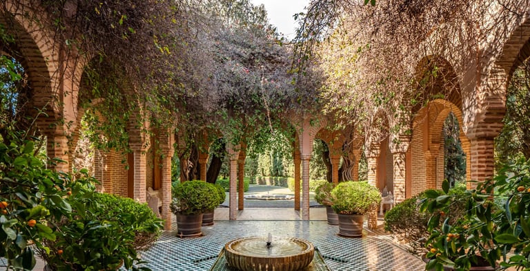 Arched brick colonnade with tiled floor and central fountain