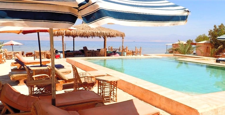 Bedouin star ras shitan lounging under the umbrella