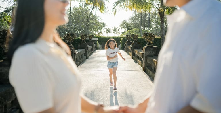 Family holding hands during a sunset photography session at InterContinental Bali Resort
