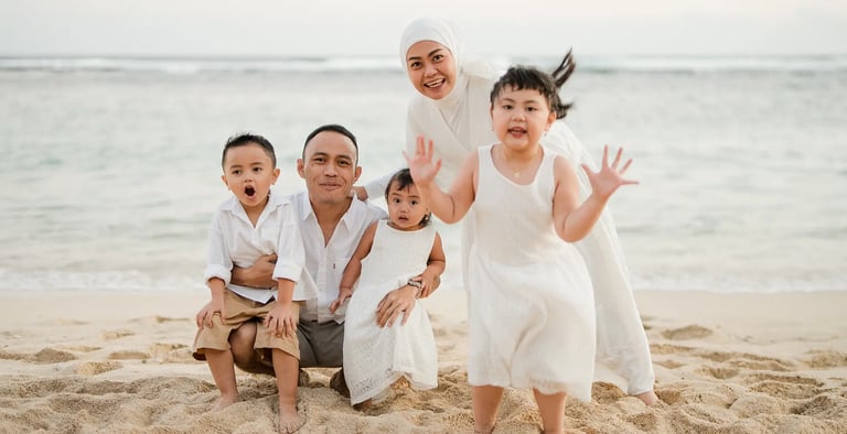 Fun and candid beach family portrait session of Ilham family at Melasti Beach Bali