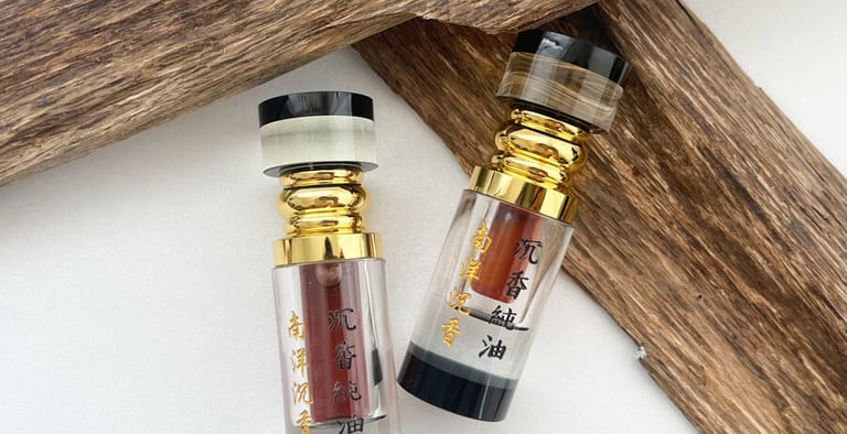 two bottles of perfumes and a wooden cross