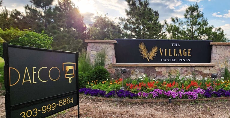 a daeco painting sign that says castle pines village